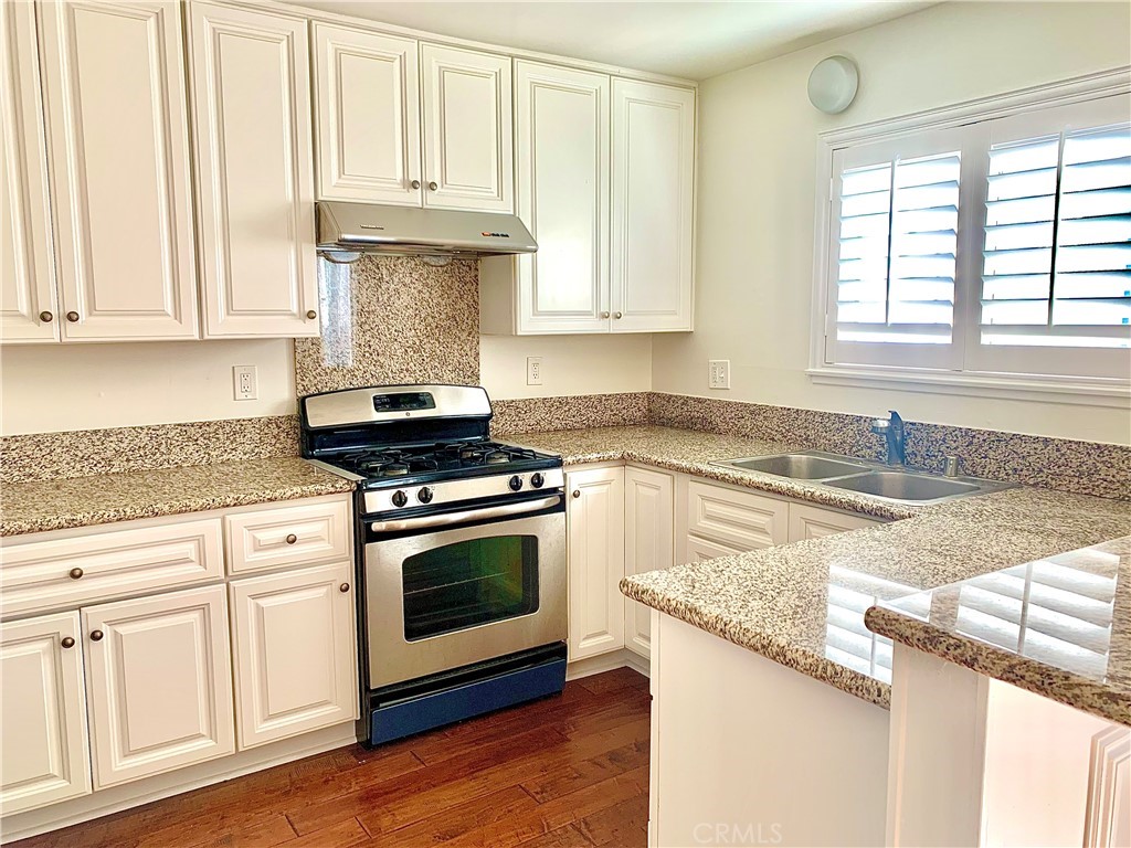 182 Brookline Lane Costa Mesa, CA 92626 - Photo 7 of 21 a kitchen with granite countertop a stove a sink and a granite counter tops