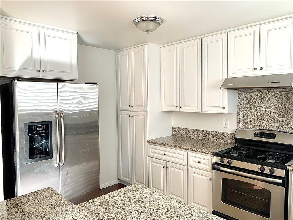 182 Brookline Lane Costa Mesa, CA 92626 - Photo 8 of 21 a kitchen with granite countertop a stove and a refrigerator
