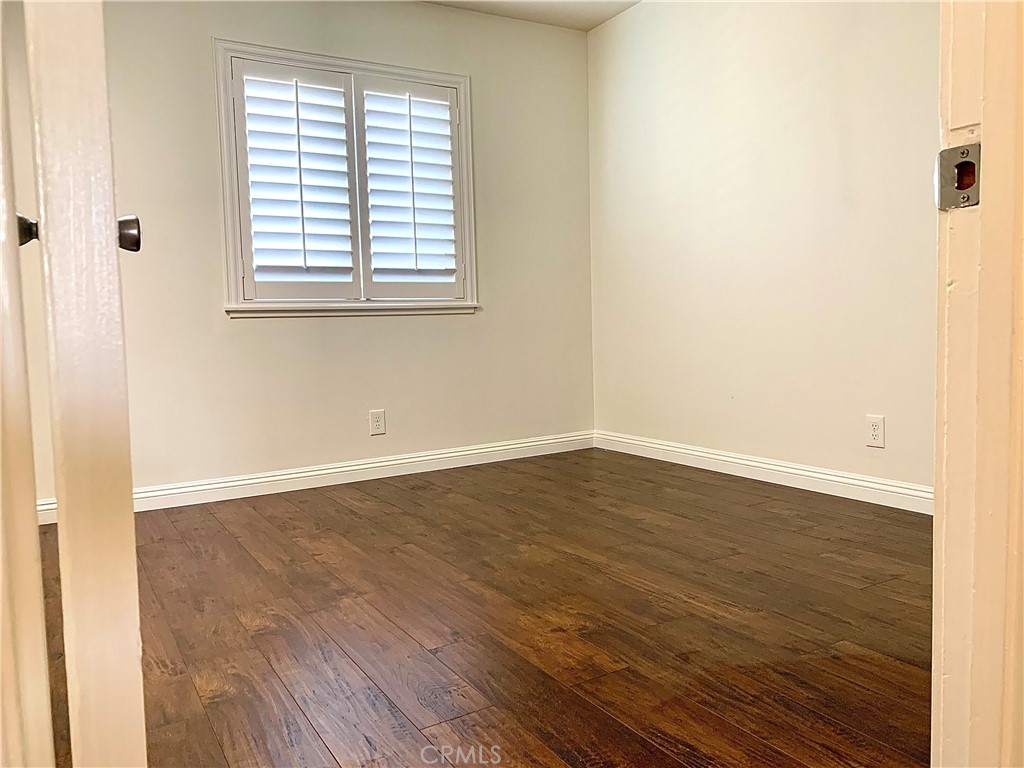 182 Brookline Lane Costa Mesa, CA 92626 - Photo 10 of 21 an empty room with wooden floor and windows