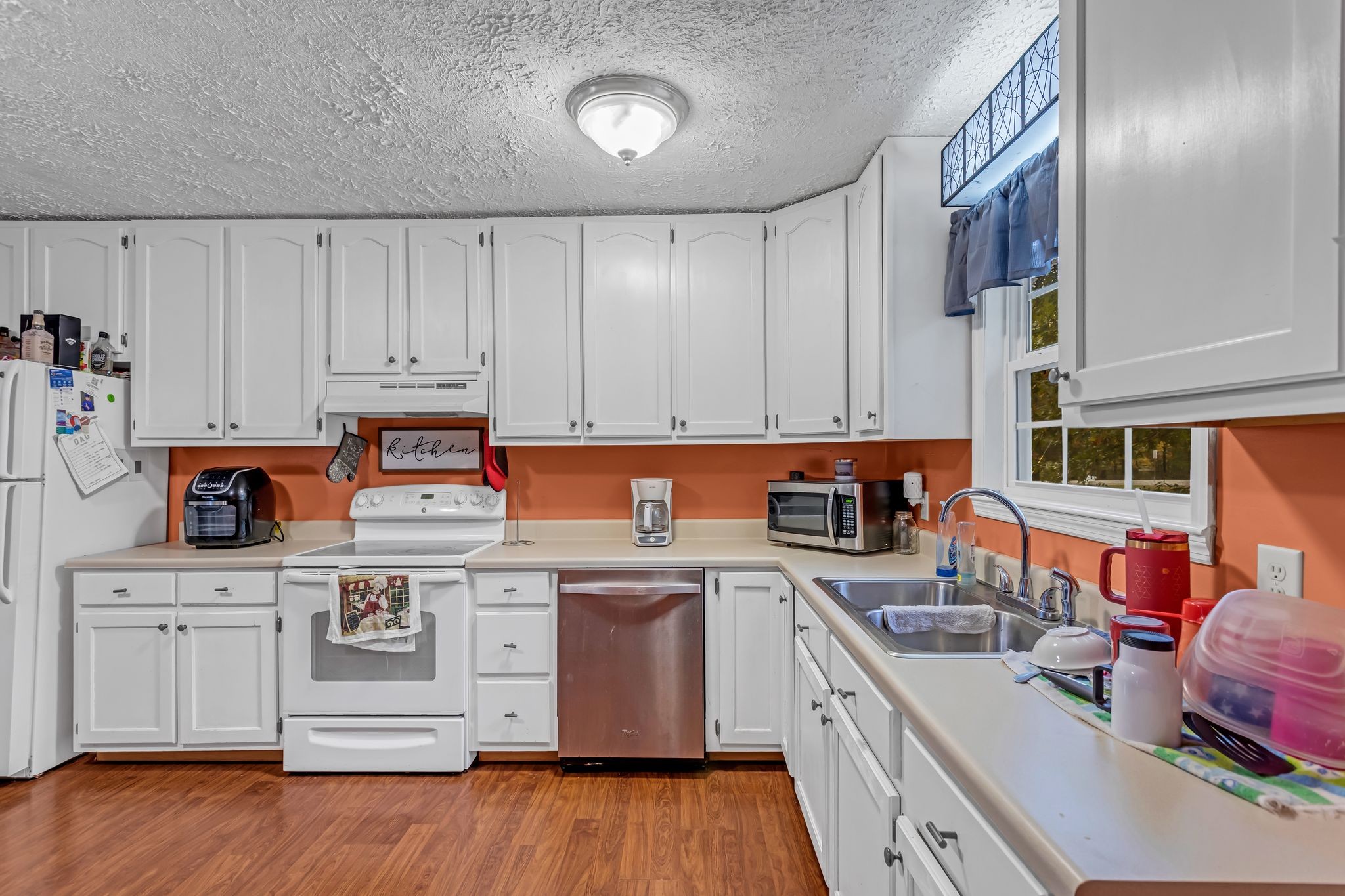 175 Reeves Road Hohenwald, TN 38462 - Photo 11 of 27 a kitchen with stainless steel appliances granite countertop a stove and a sink