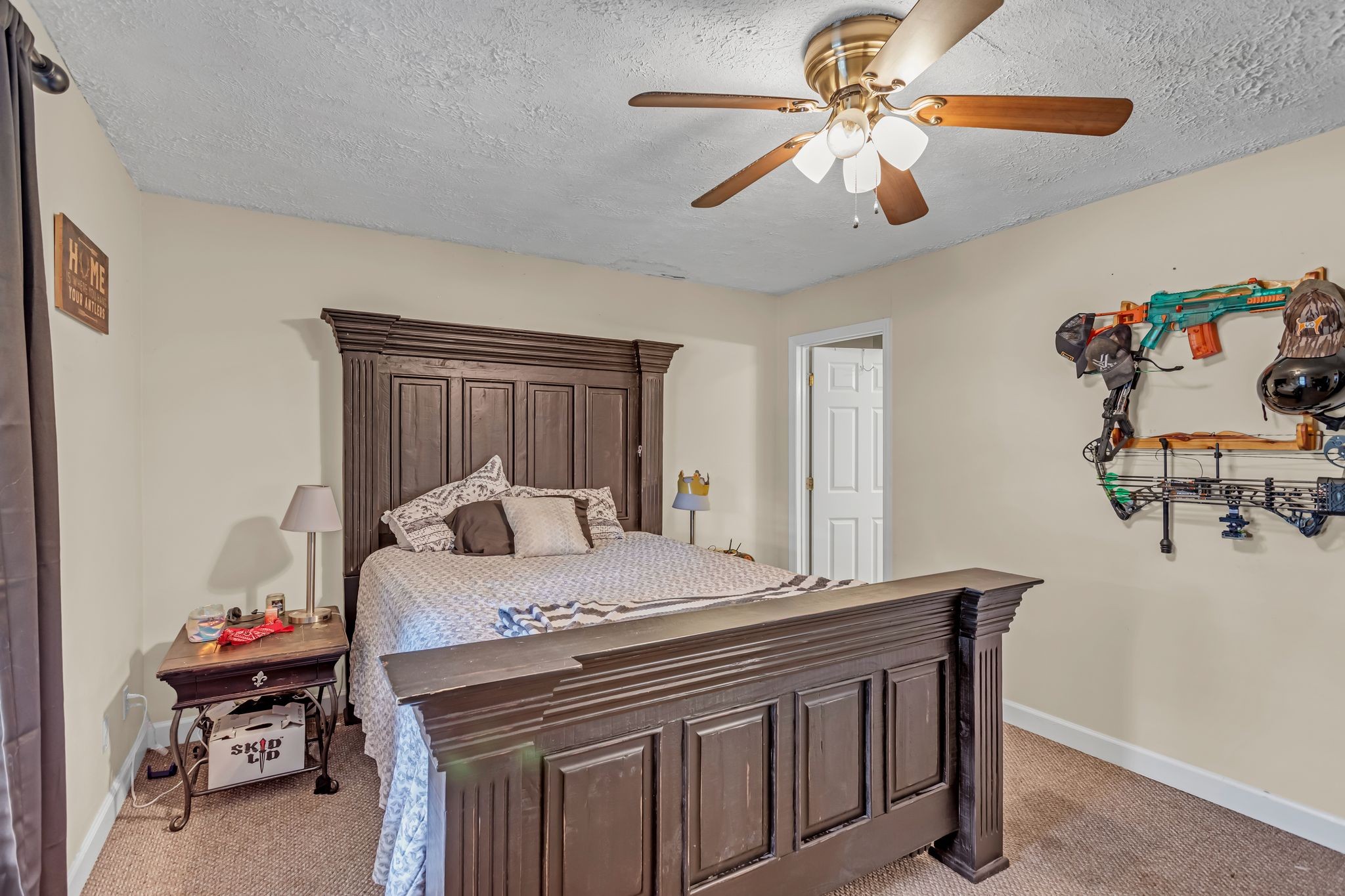 175 Reeves Road Hohenwald, TN 38462 - Photo 14 of 27 a bedroom with a bed and a chandelier