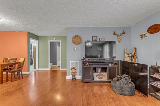 a kitchen with stainless steel appliances granite countertop a stove and a wooden floors