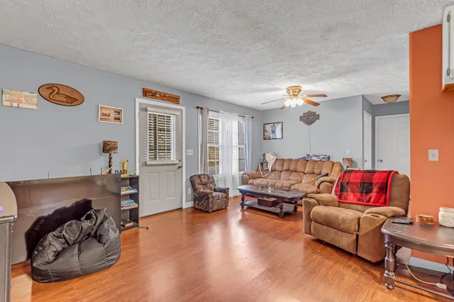 a living room with furniture and wooden floor