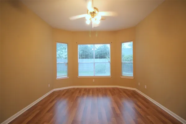 wooden floor in an empty room with a window