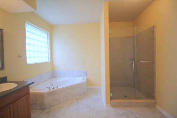 a bathroom with a bathtub and shower