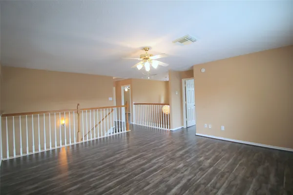 a view of a room with wooden floor