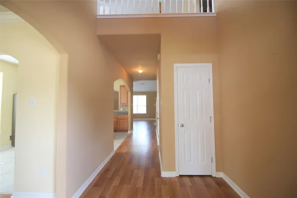 a view of a hallway with wooden floor