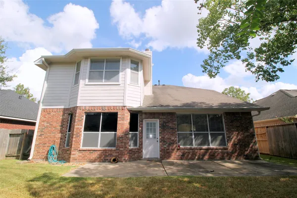 a front view of a house with a yard glass top table and chairs