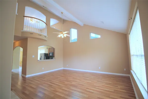 a view of empty room with wooden floor