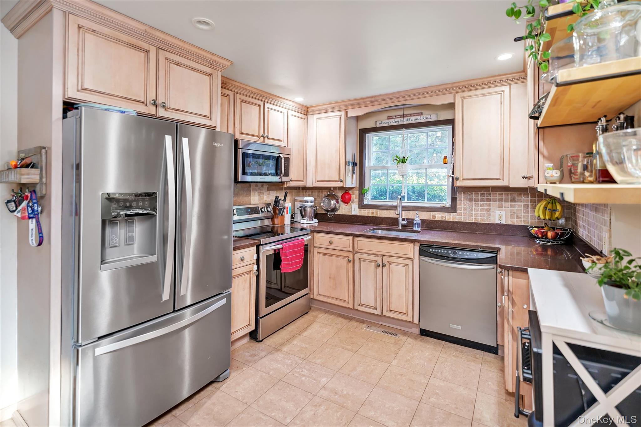 81 Beach Road Wading River, NY 11792 - Photo 20 of 25 Kitchen with stainless steel appliances, dark countertops, tasteful backsplash, light brown cabinetry, and recessed lighting