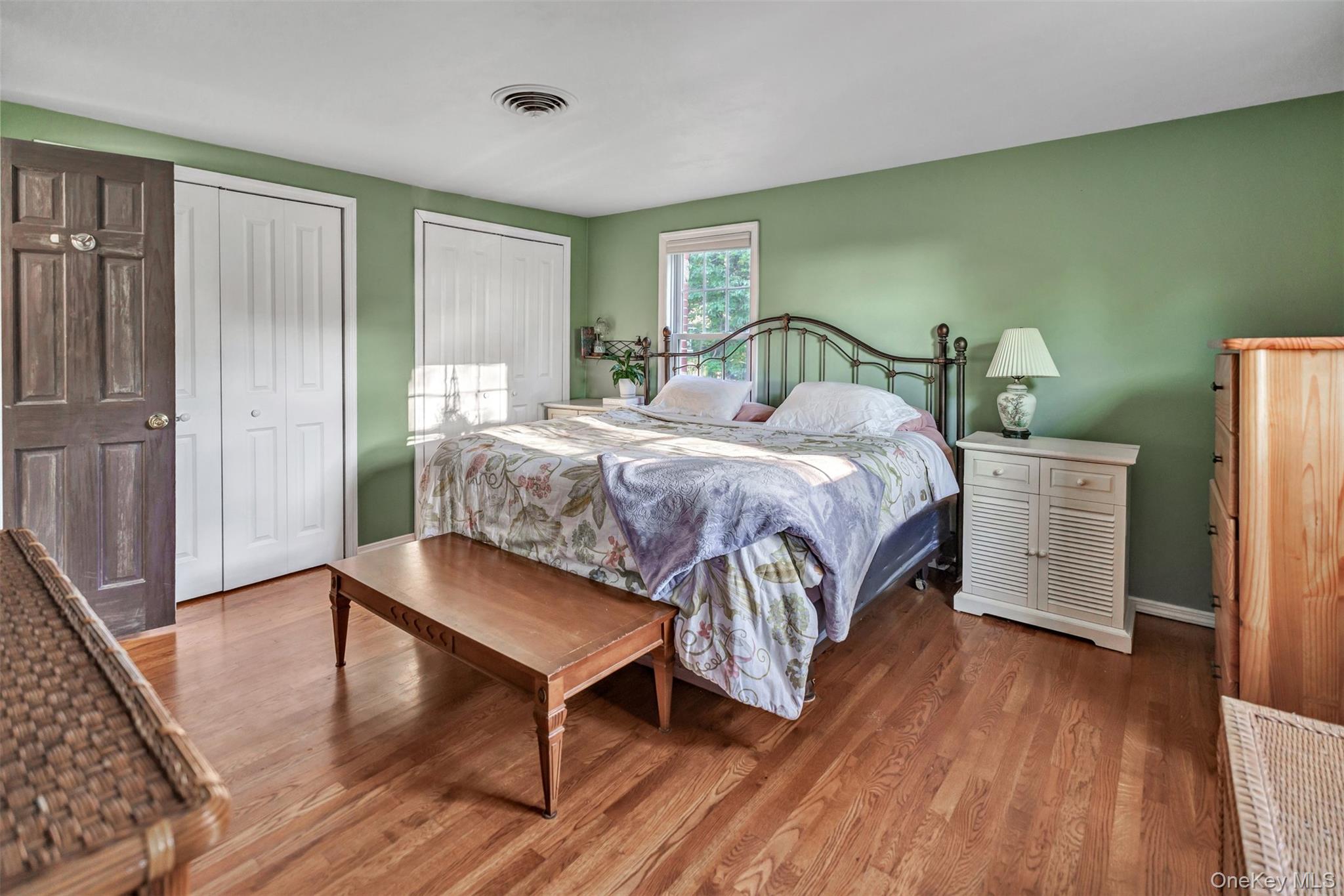 81 Beach Road Wading River, NY 11792 - Photo 6 of 25 Primary Bedroom featuring two closets and wood finished floors
