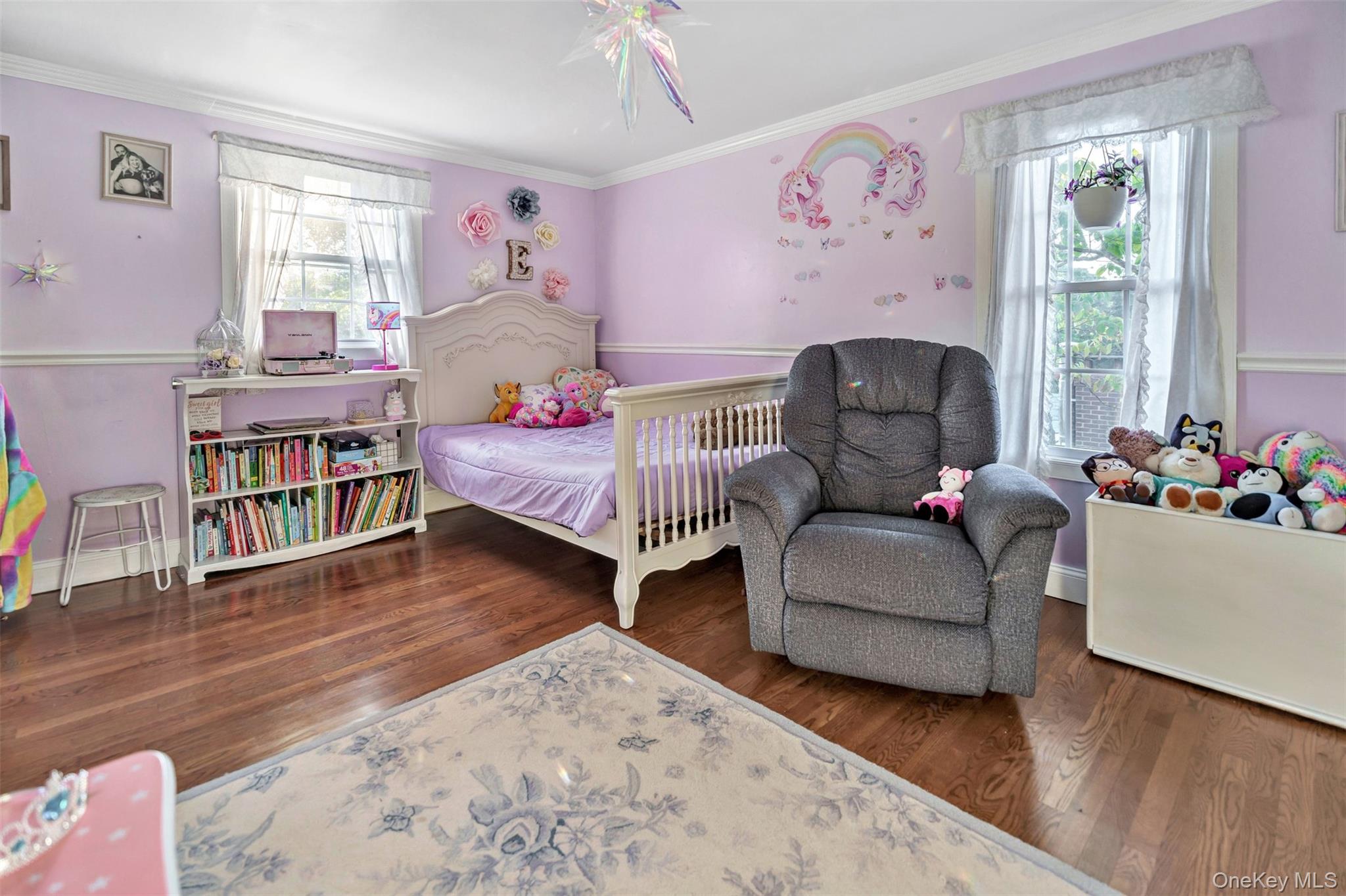 81 Beach Road Wading River, NY 11792 - Photo 7 of 25 2nd Floor Guest Bedroom with crown molding, dark wood-type flooring, multiple windows, and a ceiling fan
