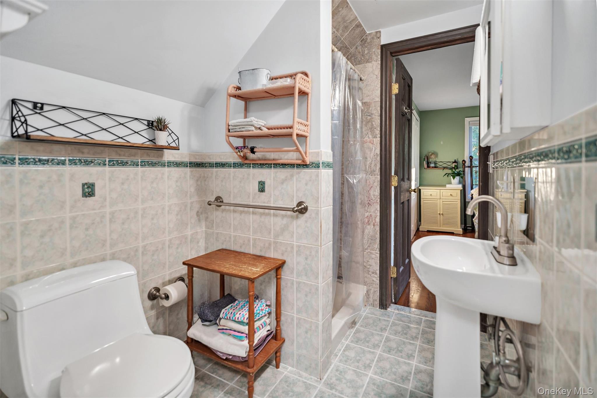 81 Beach Road Wading River, NY 11792 - Photo 8 of 25 2nd Floor Full bathroom with tile walls, a stall shower, tile patterned flooring, and a wainscoted wall