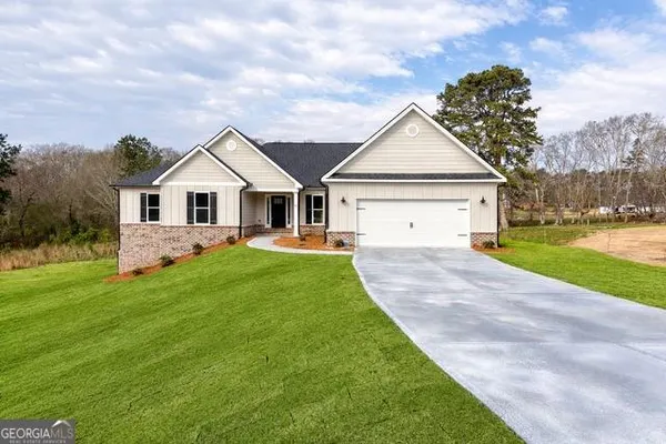 a view of a house with a yard and a garden