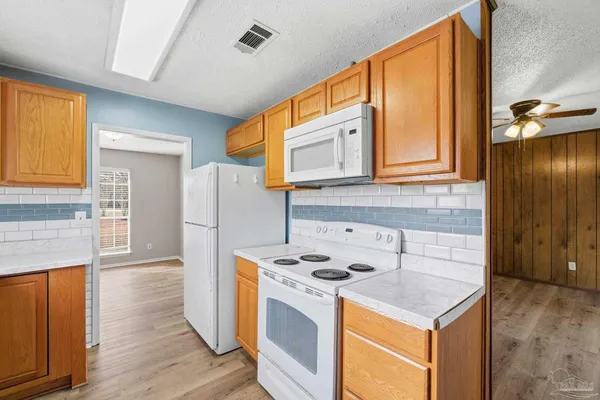 a kitchen with a sink a stove a refrigerator and cabinets