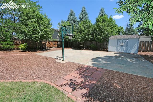 3123 Springdowns Place Colorado Springs, CO 80906 - Photo 34 of 36 Included storage shed and fenced RV parking or basketball.