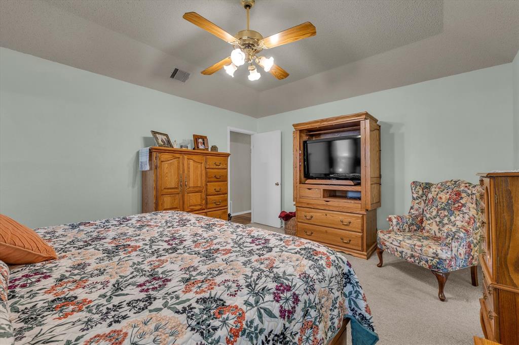 107 Fort Graham Circle Waco, TX 76705 - Photo 15 of 40 Bedroom with light colored carpet and a ceiling fan