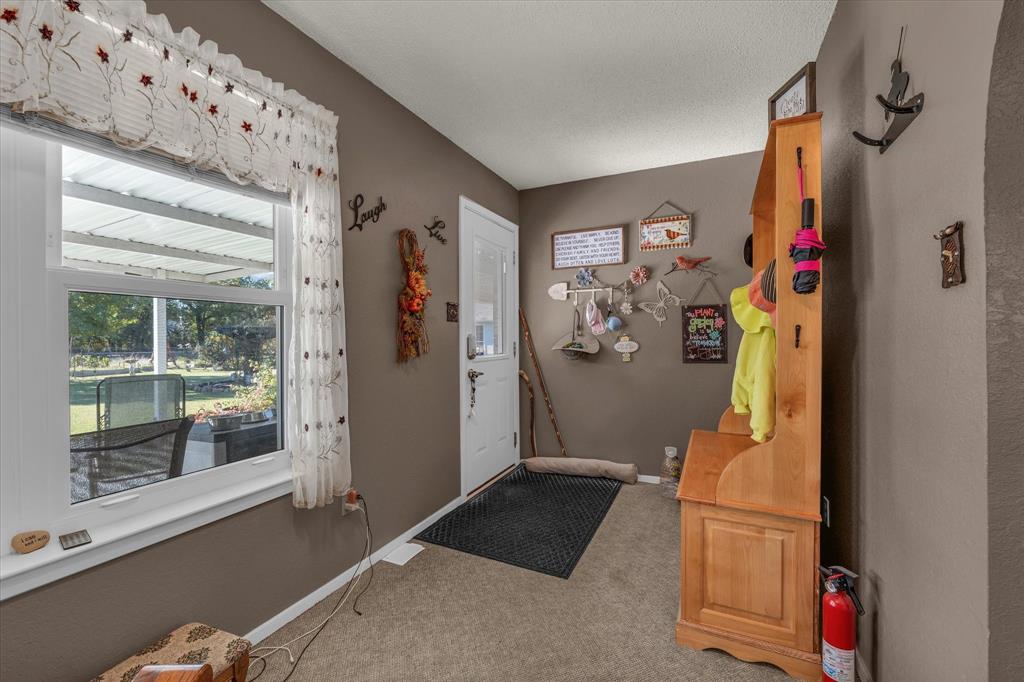 107 Fort Graham Circle Waco, TX 76705 - Photo 9 of 40 Entrance foyer with light colored carpet and baseboards