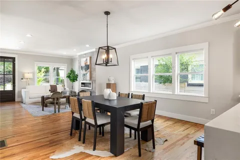 a view of a dining room with furniture window and wooden floor