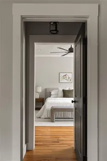 a bedroom with a bed and a mirror