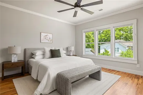 a bedroom with a bed and a large window