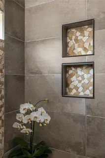 a bathroom with a painting on the wall and a shower