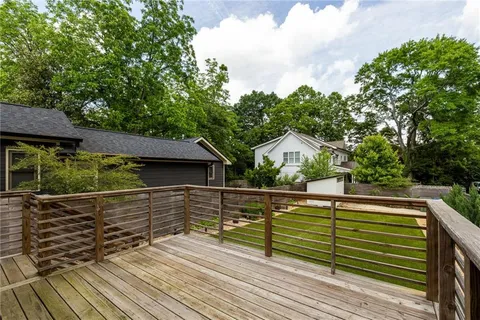 a view of a roof deck with wooden fence