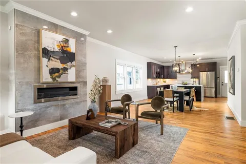 a living room with furniture and kitchen view