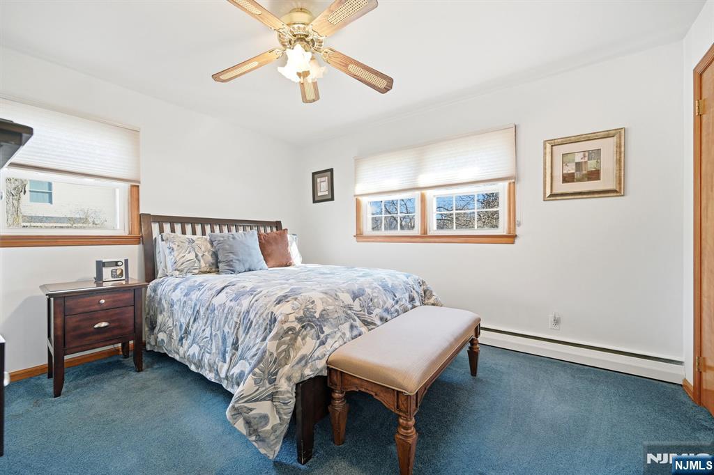 49 Mill Road Park Ridge, NJ 07656 - Photo 18 of 34 a bedroom with a bed and a chandelier