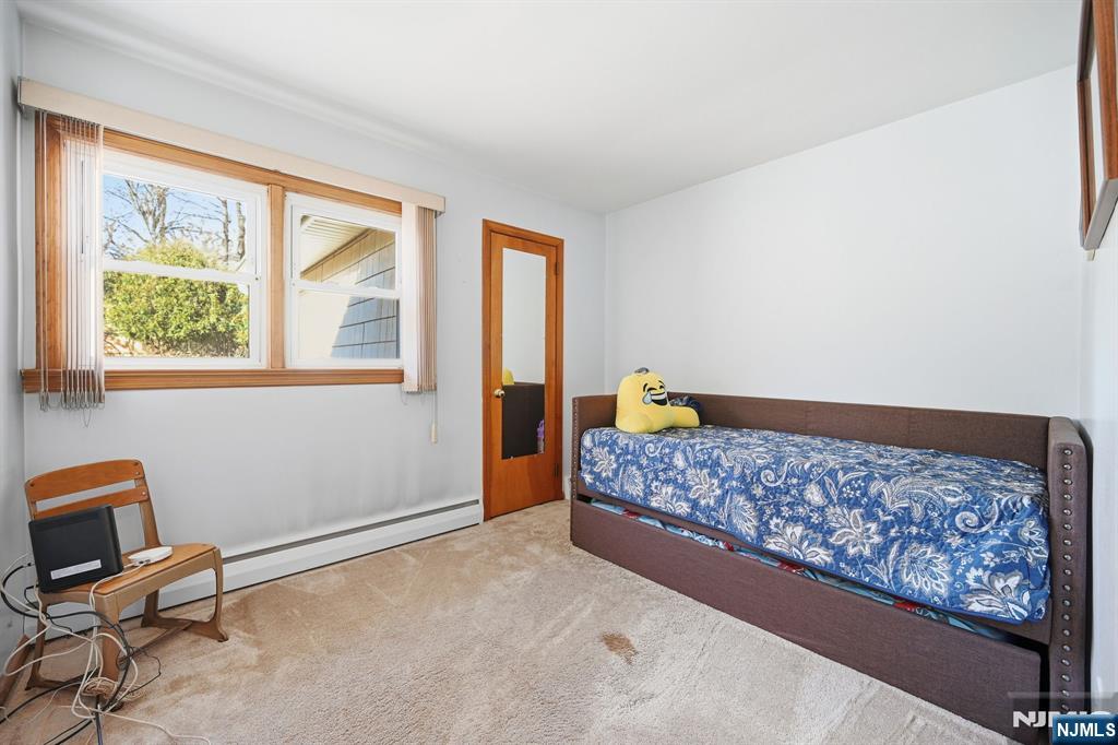 49 Mill Road Park Ridge, NJ 07656 - Photo 20 of 34 a bedroom with a bed a chair and next to a window