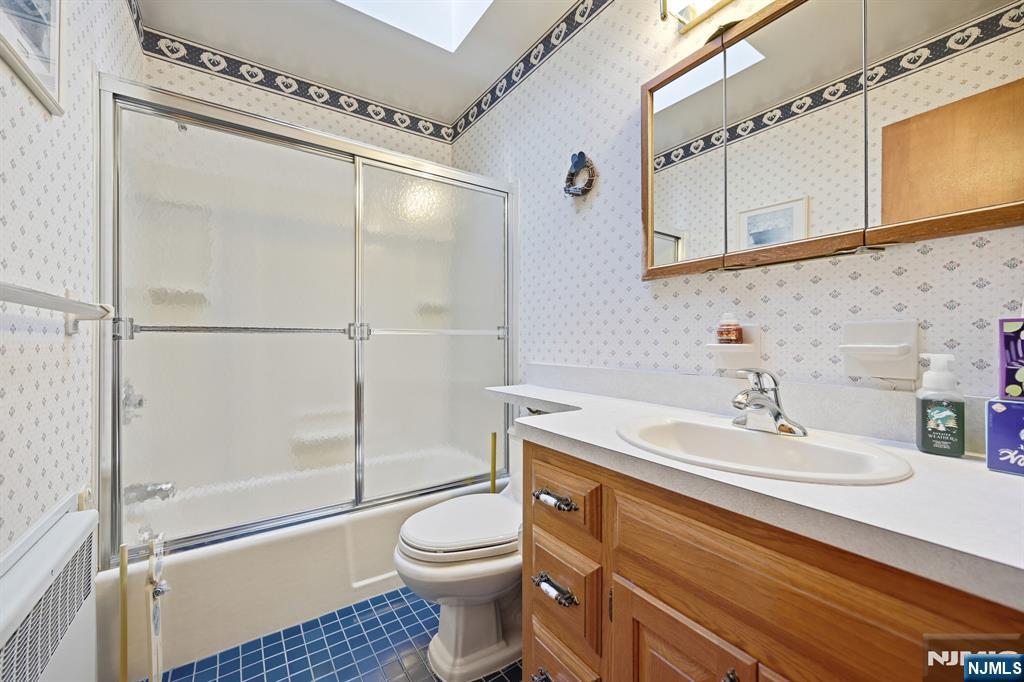 49 Mill Road Park Ridge, NJ 07656 - Photo 21 of 34 a bathroom with a sink a toilet and shower
