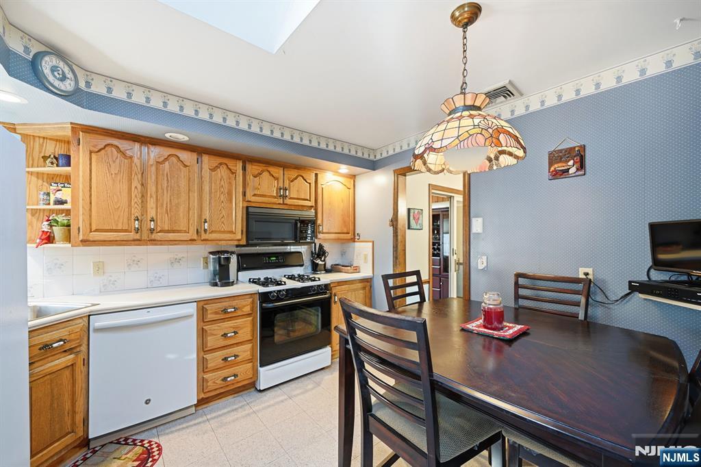 49 Mill Road Park Ridge, NJ 07656 - Photo 8 of 34 a kitchen with a table chairs stove and cabinets