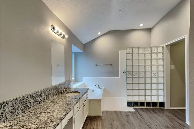 a bathroom with a sink and mirror