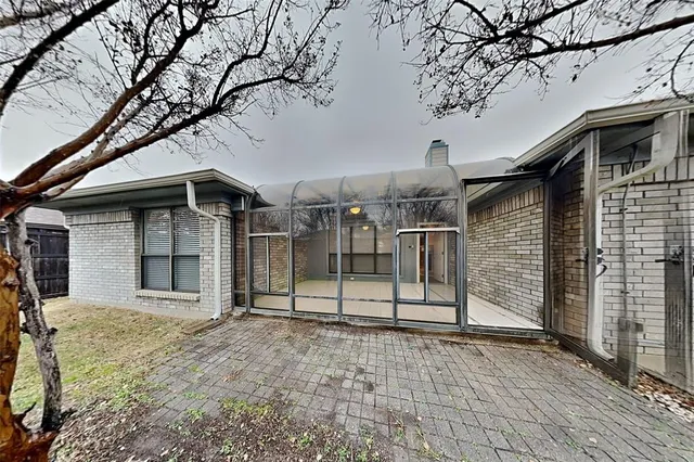 a view of a house with a large tree