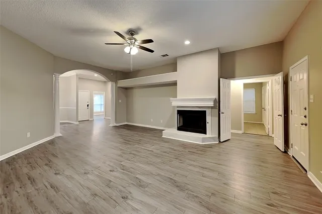 a view of a livingroom with wooden floor and a ceiling fan