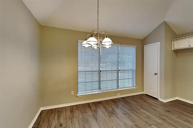 a view of wooden floor and windows in a room