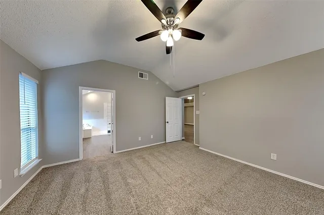 a view of an empty room and a ceiling fan