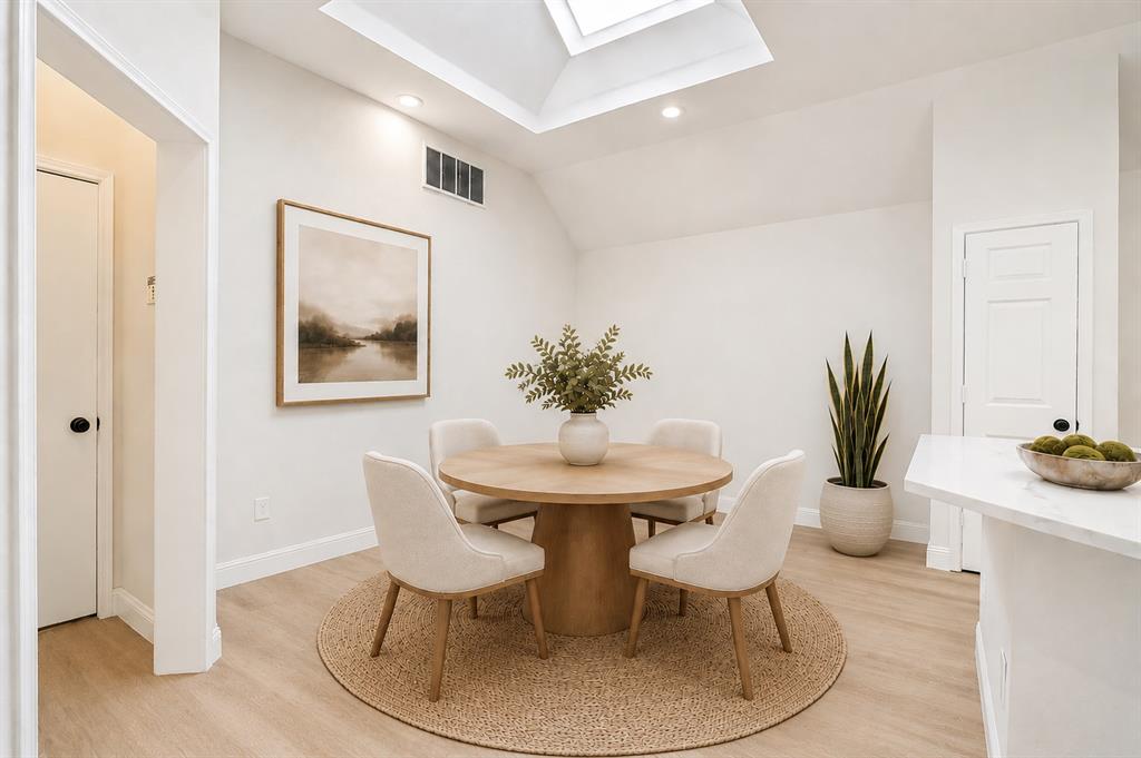 3020 Ridge Hollow Drive Plano, TX 75023 - Photo 12 of 28 Dining area featuring a skylight, recessed lighting, and wood-finish flooring
