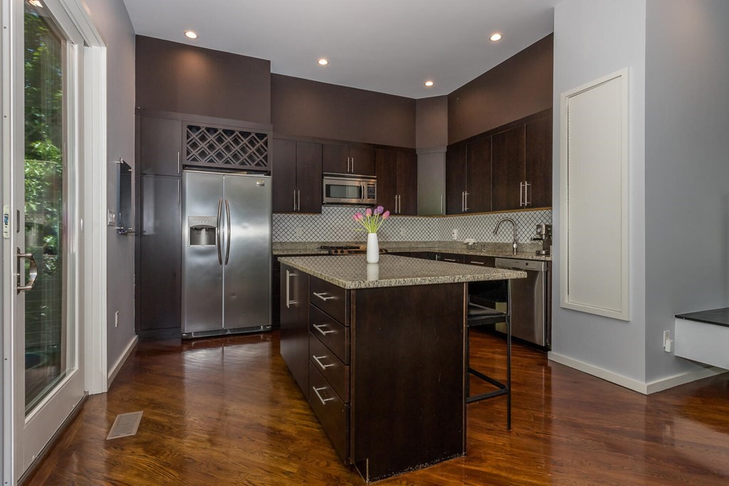 12 Endicott Place Canton, MA 02021 - Photo 5 of 17 a kitchen with kitchen island granite countertop a refrigerator and a sink