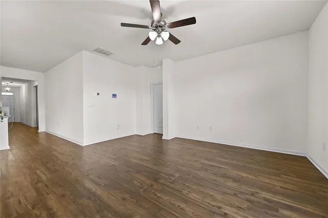 a view of an empty room with a ceiling fan