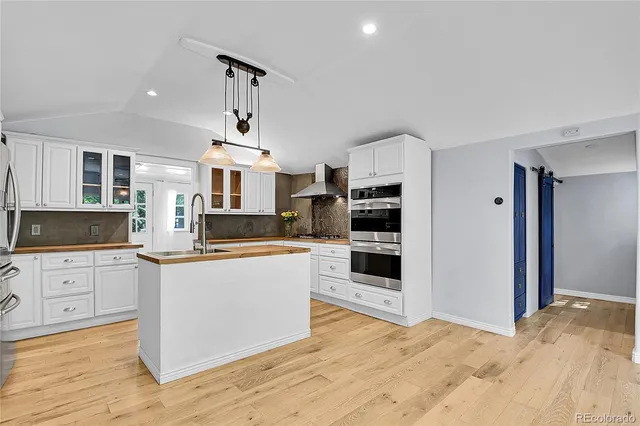 a kitchen with granite countertop a sink and cabinets