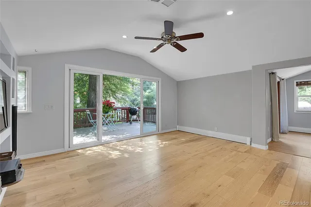 a view of a livingroom with wooden floor and a flat screen tv