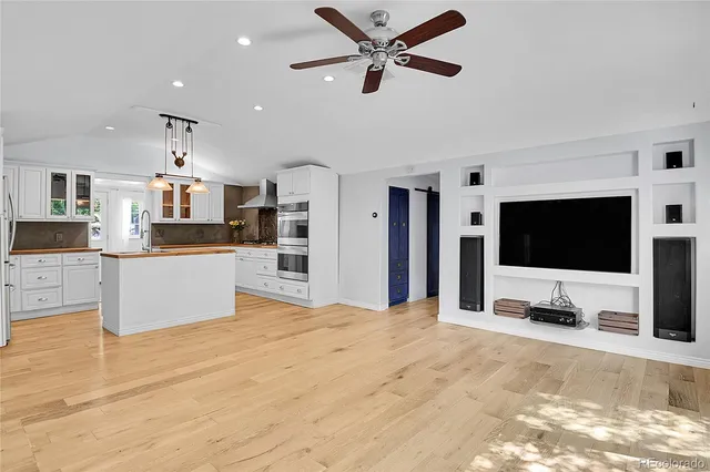 a living room with a flat screen tv and a fireplace