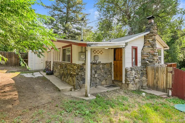 front view of a house with a large tree