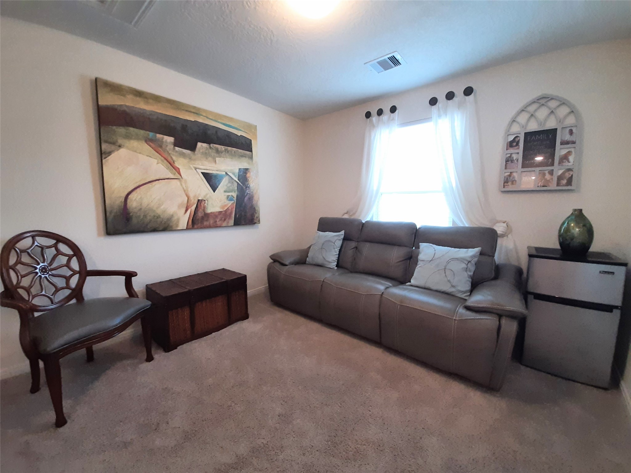 3322 Forest Chitto Dr Spring Spring, TX 77373 - Photo 14 of 18 a living room with furniture and a painting on the wall