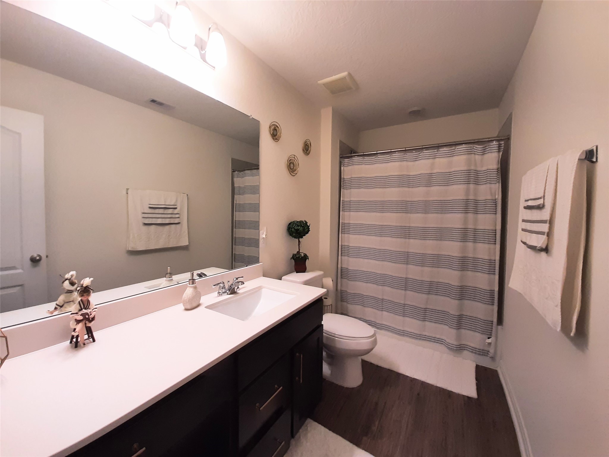 3322 Forest Chitto Dr Spring Spring, TX 77373 - Photo 17 of 18 a bathroom with a sink a toilet a shower and a mirror