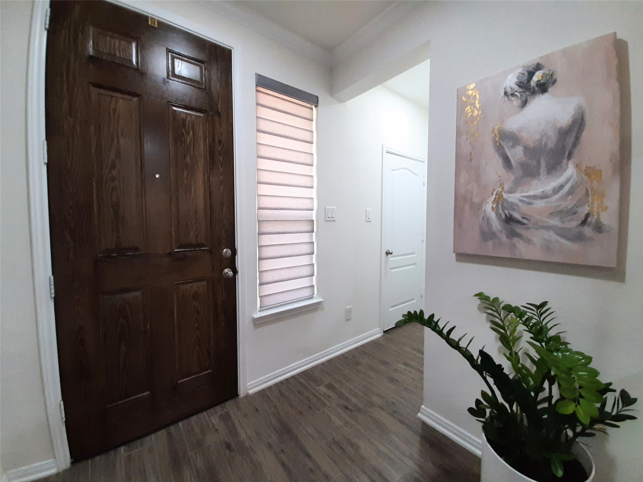 3322 Forest Chitto Dr Spring Spring, TX 77373 - Photo 3 of 18 a view of a hallway with wooden floor and a potted plant