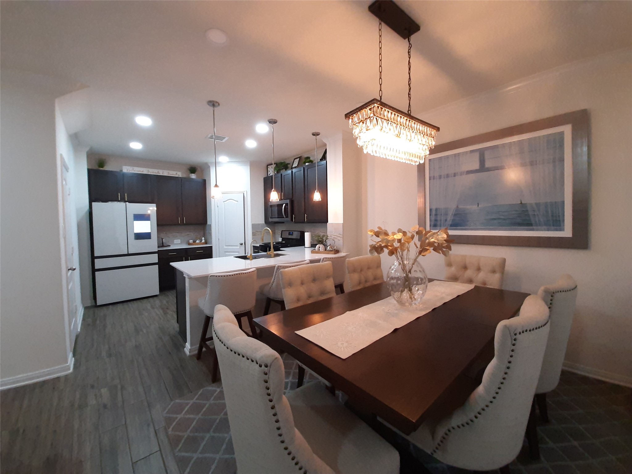 3322 Forest Chitto Dr Spring Spring, TX 77373 - Photo 7 of 18 a view of a dining room and livingroom with furniture wooden floor a chandelier