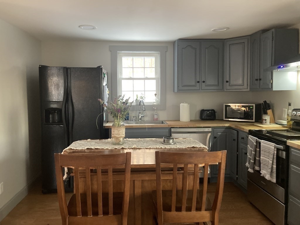 3 Pine Street Gardner, MA 01440 - Photo 11 of 32 a kitchen with stainless steel appliances granite countertop a stove a refrigerator a sink a stove and island