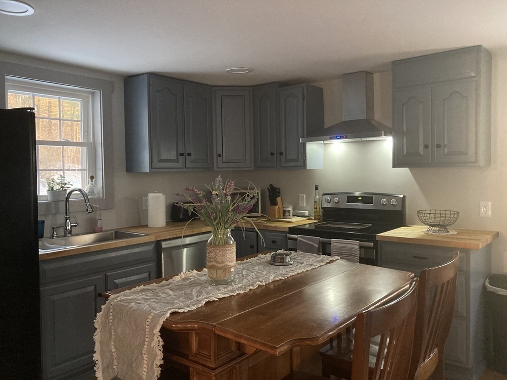 3 Pine Street Gardner, MA 01440 - Photo 12 of 32 a kitchen with a stove a sink and a refrigerator